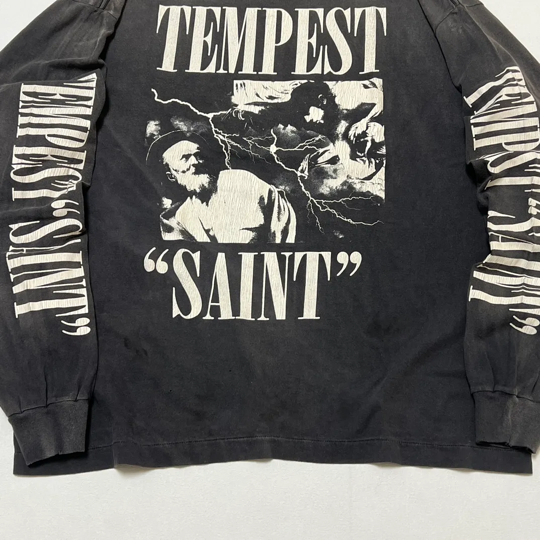 SAINT Mxxxxxx LS TEE/TEMPEST/BLK 'TEMPEST SAINT' Storm Religious Saints Cracked Retro Vulcanized Heavy Wash Long Sleeves Washed Black S-XL Assute Dyeing Multi-bit Horse Fading Craftsmanship Grinding and Hanging Holes Full of Old Feeling Top Printing Craftsmanship Purchasing Level
